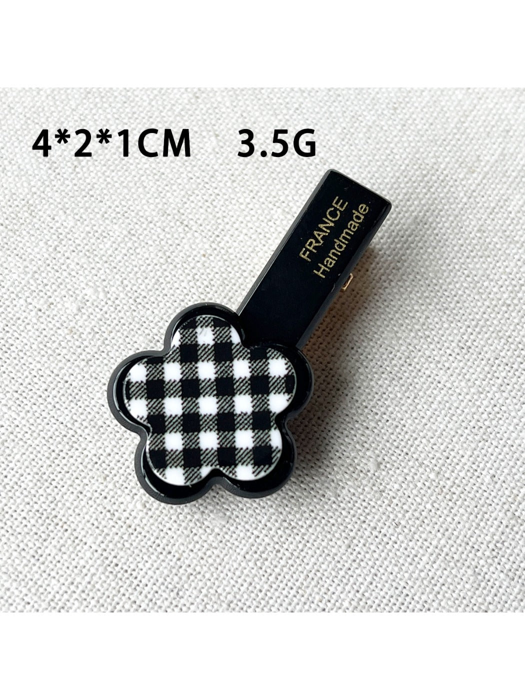 Beau acrylic hair clip shown clipped in brown hair with flower and heart accents