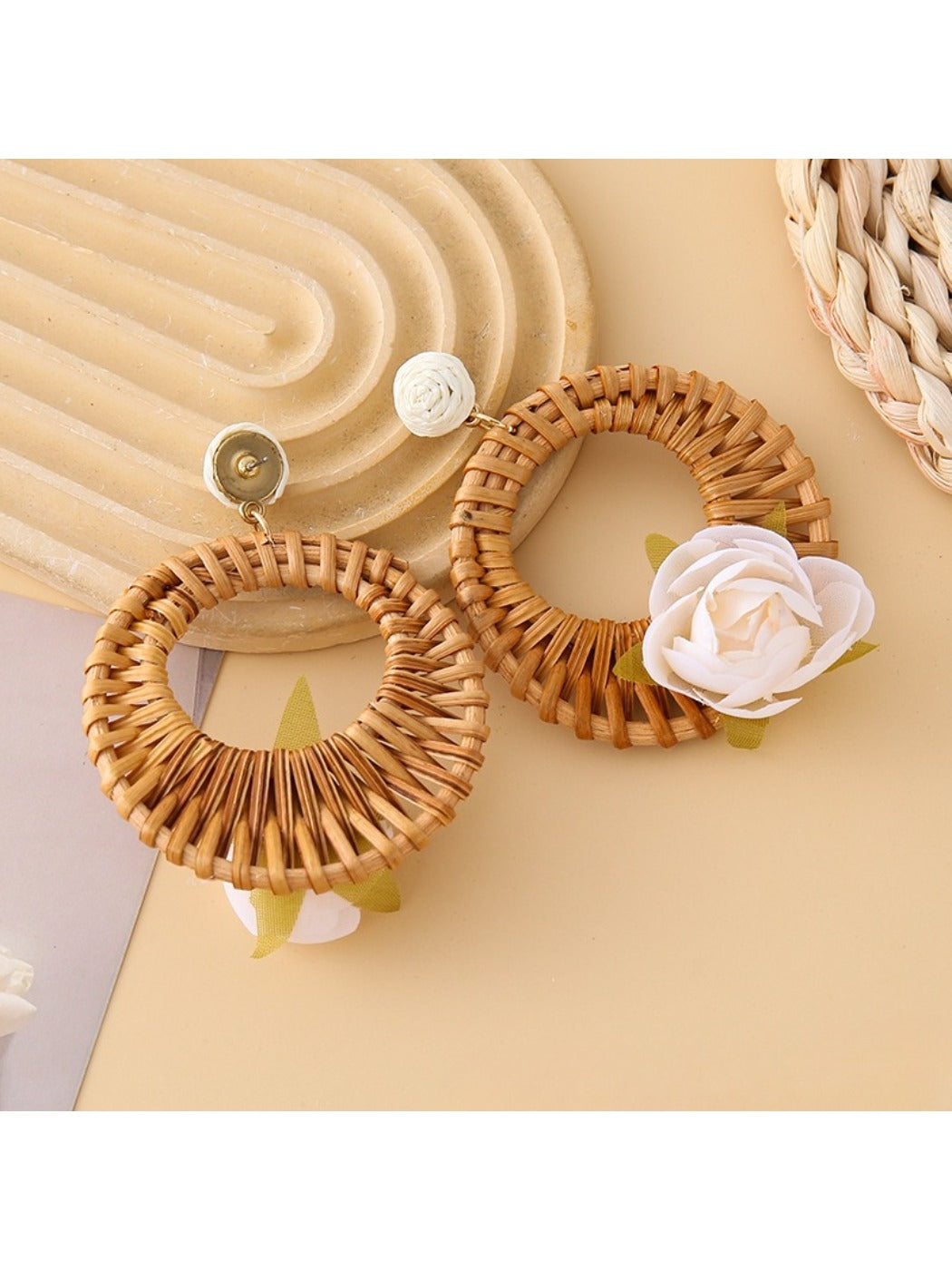 Pair of vintage rattan woven circle earrings displayed on white background