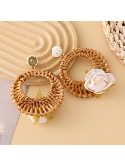 Pair of vintage rattan woven circle earrings displayed on white background