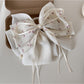 Beau elegant bow hair claw clip styled in medium-length brown hair