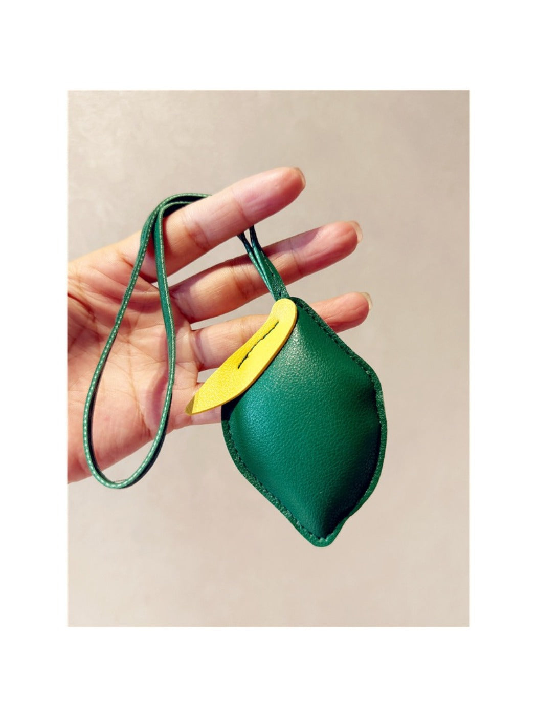 Multiple lemon-shaped keychains displayed together on a flat surface