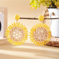 Side view of sunflower shaped drop earring highlighting its thickness and texture