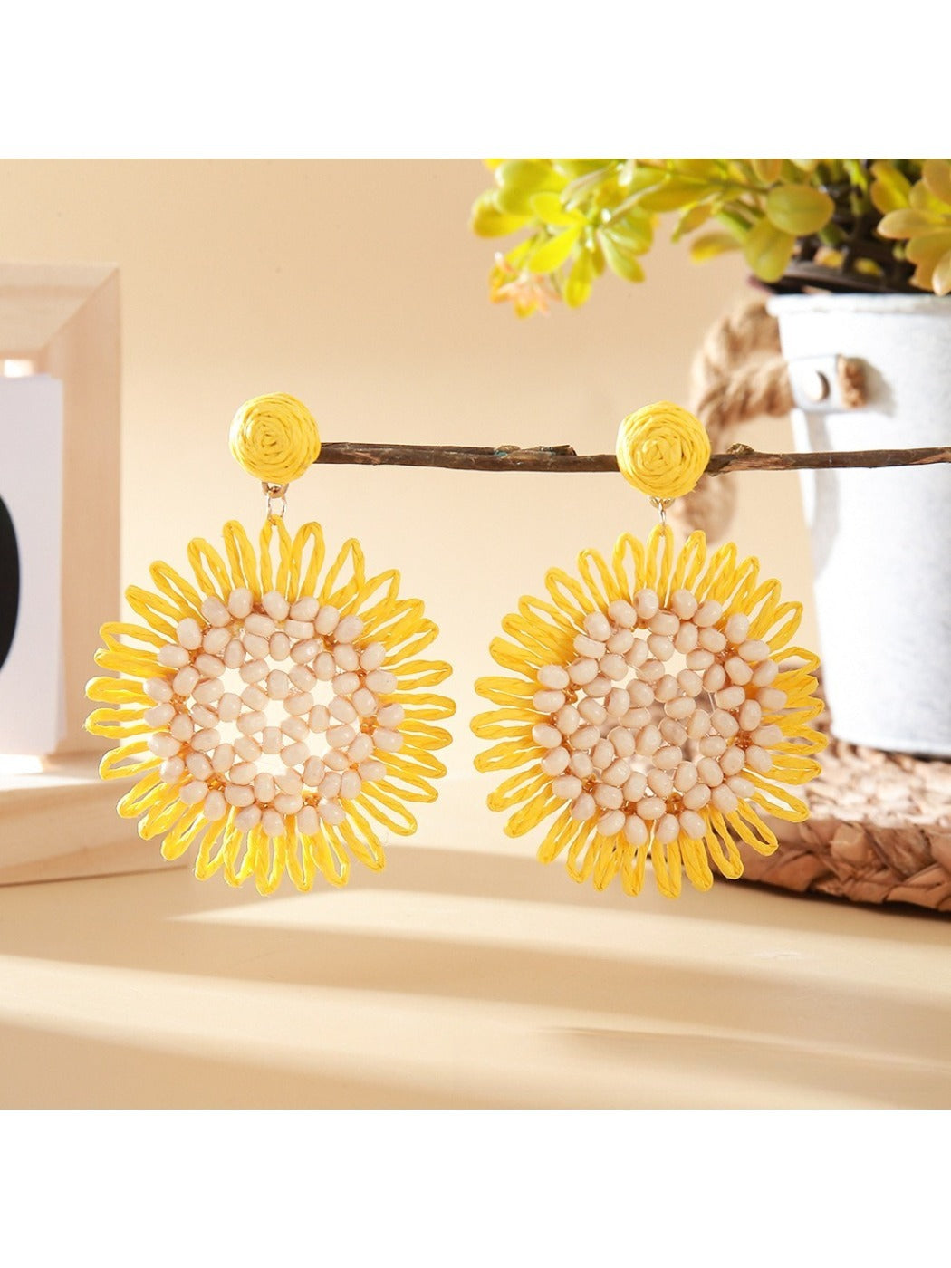 Side view of sunflower shaped drop earring highlighting its thickness and texture