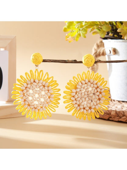 Side view of sunflower shaped drop earring highlighting its thickness and texture