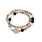 Side view of Lovra multi-wrap bracelet with alternating black and gold crystals