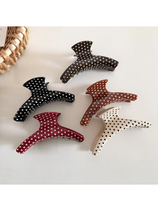 Beau polka dot acetate hair clip with black and white pattern on a white background