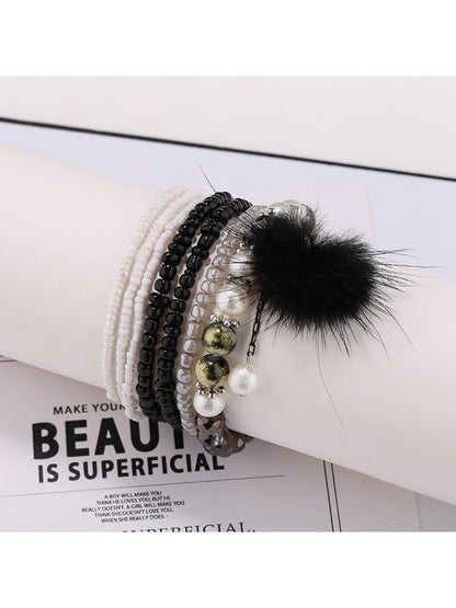 Lovra bracelet styled with casual outfit showing pompom pendant and beads