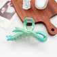Beau ombre heart shaped bow claw clip displayed with soft focus background