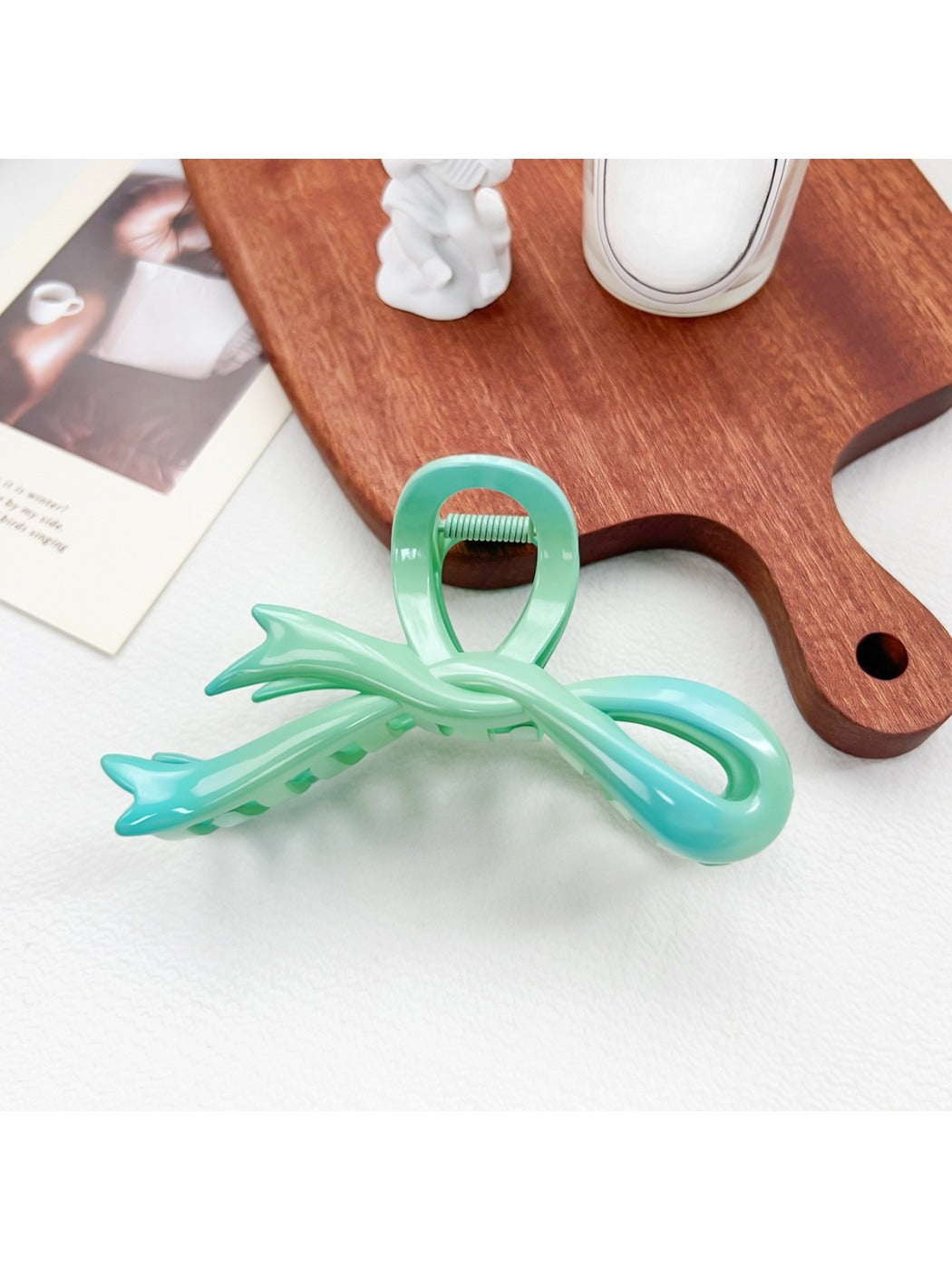 Beau ombre heart shaped bow claw clip displayed with soft focus background