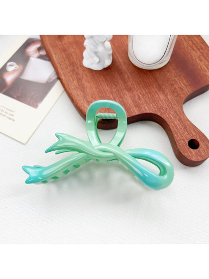 Beau ombre heart shaped bow claw clip displayed with soft focus background
