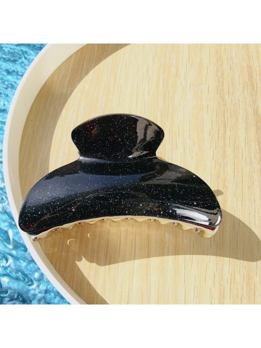 Beau claw clip held in hand displaying size and pattern details