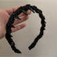 Close-up of the wavy beaded design on the Gifty headband showing intricate beadwork