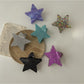 Beau star shaped claw clip open, displaying inner claw grips