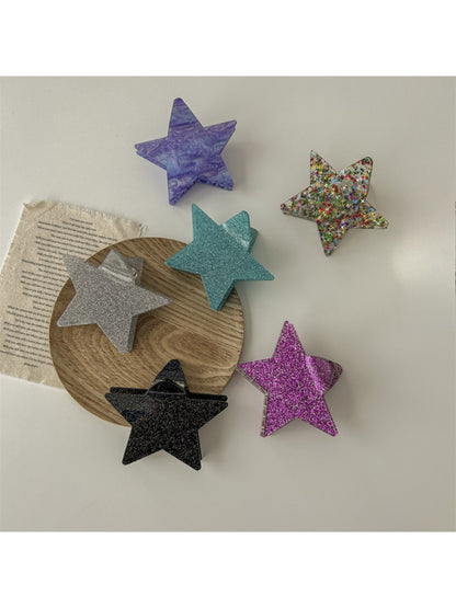 Beau star shaped claw clip open, displaying inner claw grips