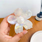 Flower hair claw clip with bright petals shown from an angled perspective