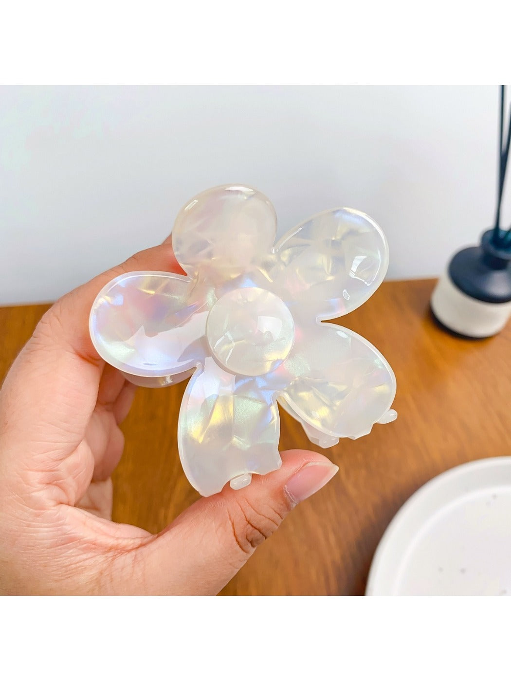 Flower hair claw clip with bright petals shown from an angled perspective