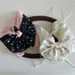 Side view of Beau Sweet Tiny Floral Bow Claw Clip displaying bow shape