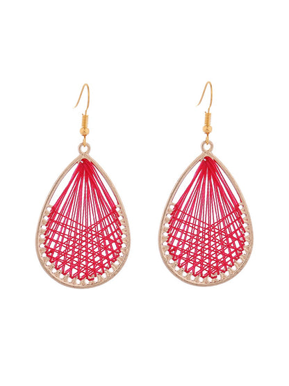 Earedge Cord Woven Teardrop Earrings worn by a model with short hair