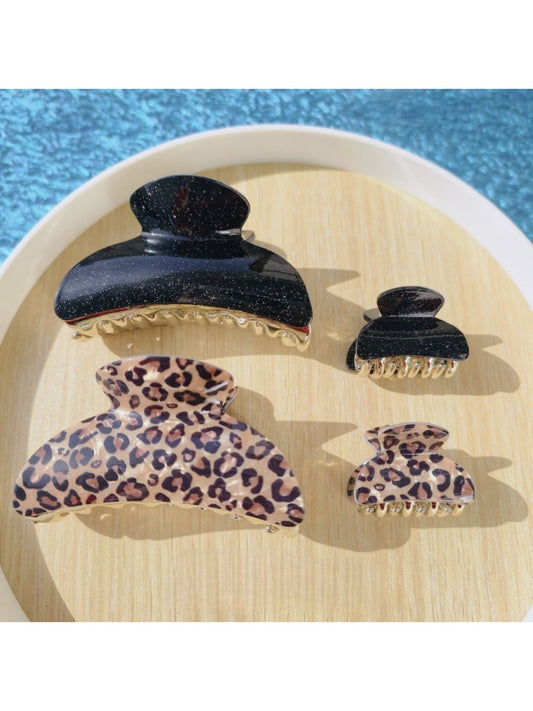 Black glitter and leopard print claw hair clip on white background