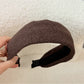 Gifty headband resting on a textured fabric background