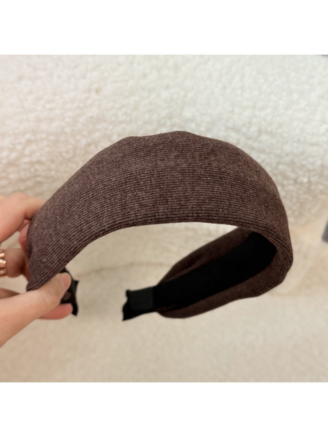 Gifty headband resting on a textured fabric background