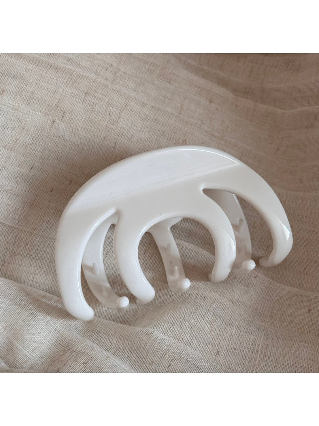 Beau hair clip worn in long brown hair, securing a section