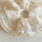 Gifty ruched scrunchie styled on a wrist as a fashion accessory