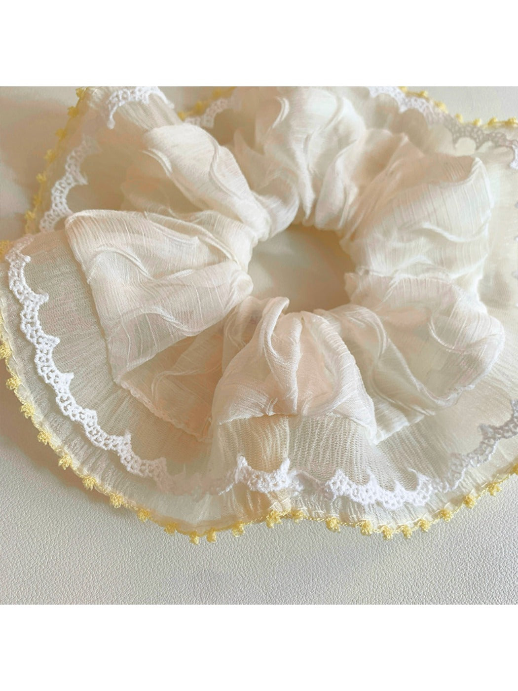 Gifty ruched scrunchie styled on a wrist as a fashion accessory