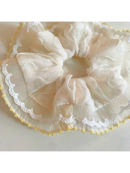 Gifty ruched scrunchie styled on a wrist as a fashion accessory