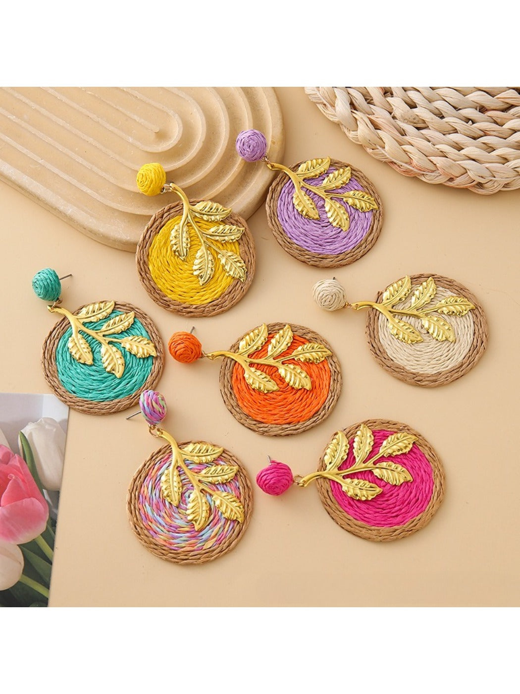 Close-up of Earedge round leaf pendant earrings in gold finish
