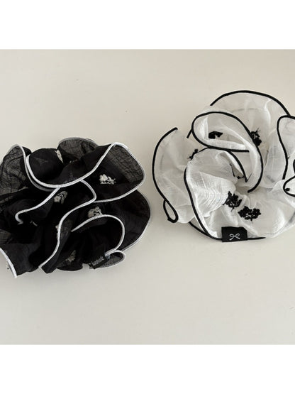 Fresh elegant scrunchie styled on a wrist with natural lighting