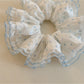 Polka dot scrunchie styled on a wrist as a fashion accessory