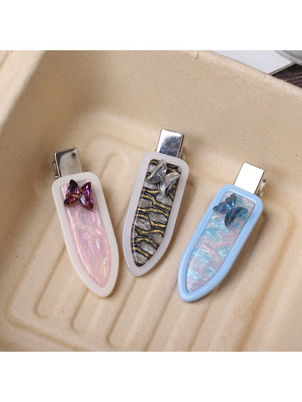 Close-up of Beau butterfly hair clip showing smooth acetate surface and oval shape