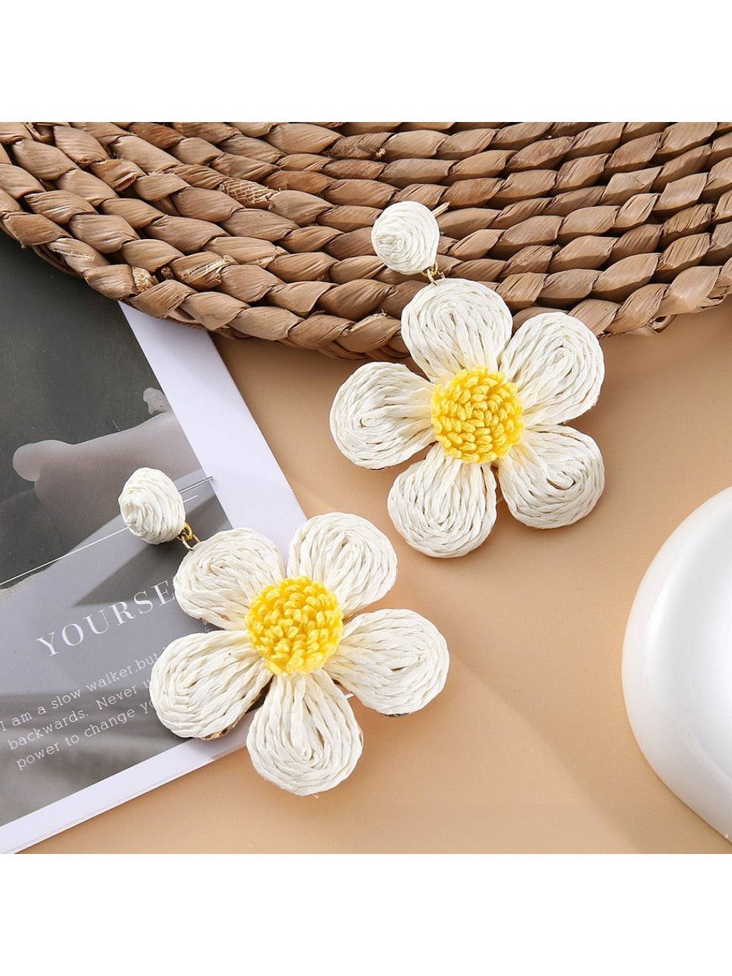 Earedge flower shaped drop earrings worn on a model's ear