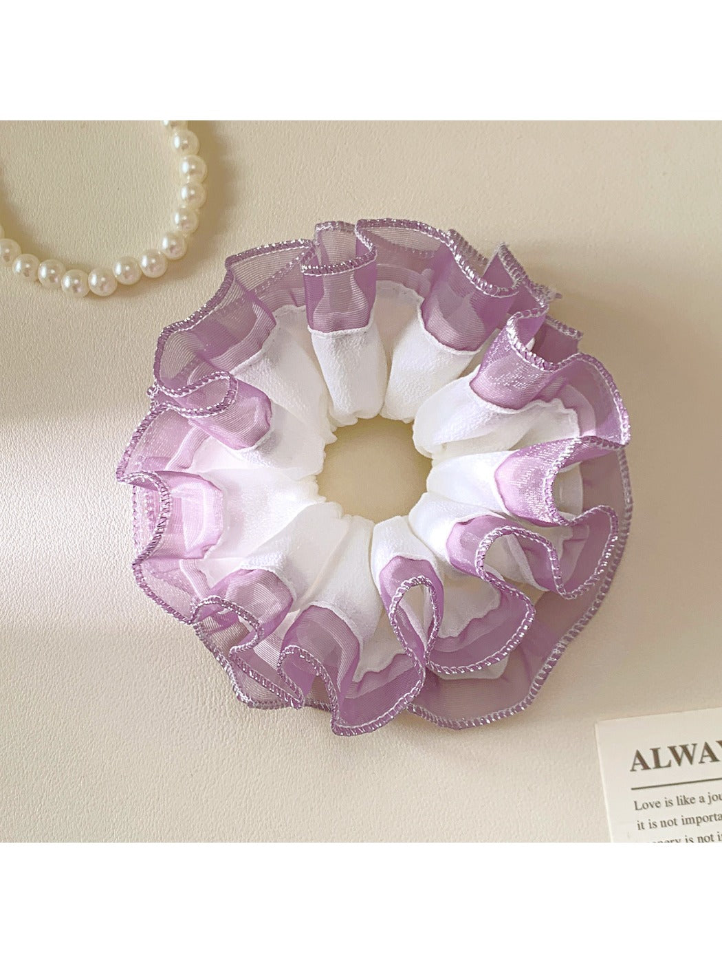 Close-up of Gifty minimalist tulle ruffle scrunchie in soft pink fabric