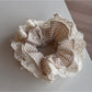 Multiple Gifty lace scrunchies in different colors arranged together to show variety