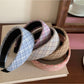 Side view of the wide plaid headband on a model with casual outfit