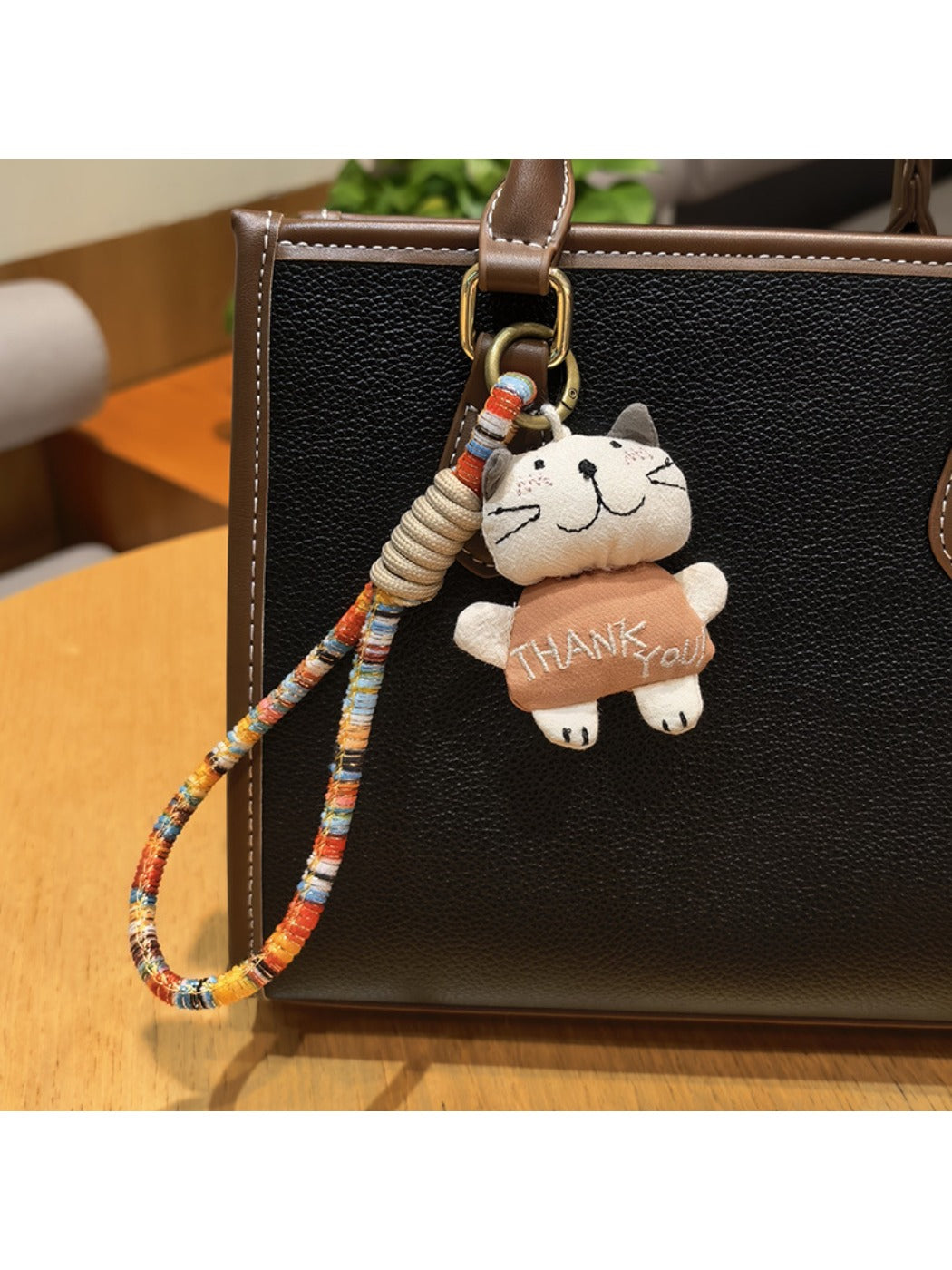 Trendy cat charm keychain with detailed cat face design on a white surface