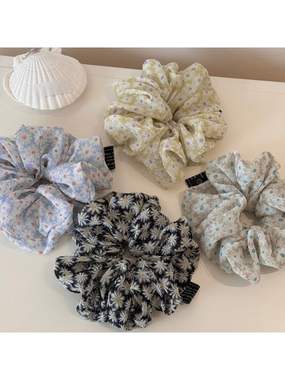 Gifty daisy print scrunchie displayed on a white background showing full circular shape
