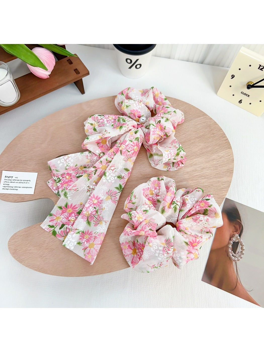 Side view of Gifty bow accented floral scrunchie highlighting fabric texture and ruffles