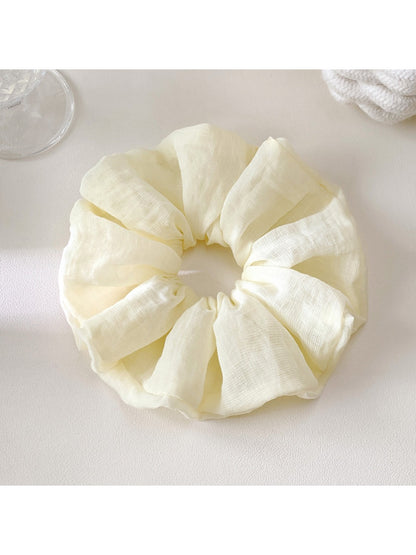 Scrunchie styled on a wrist as a casual accessory with bright colors