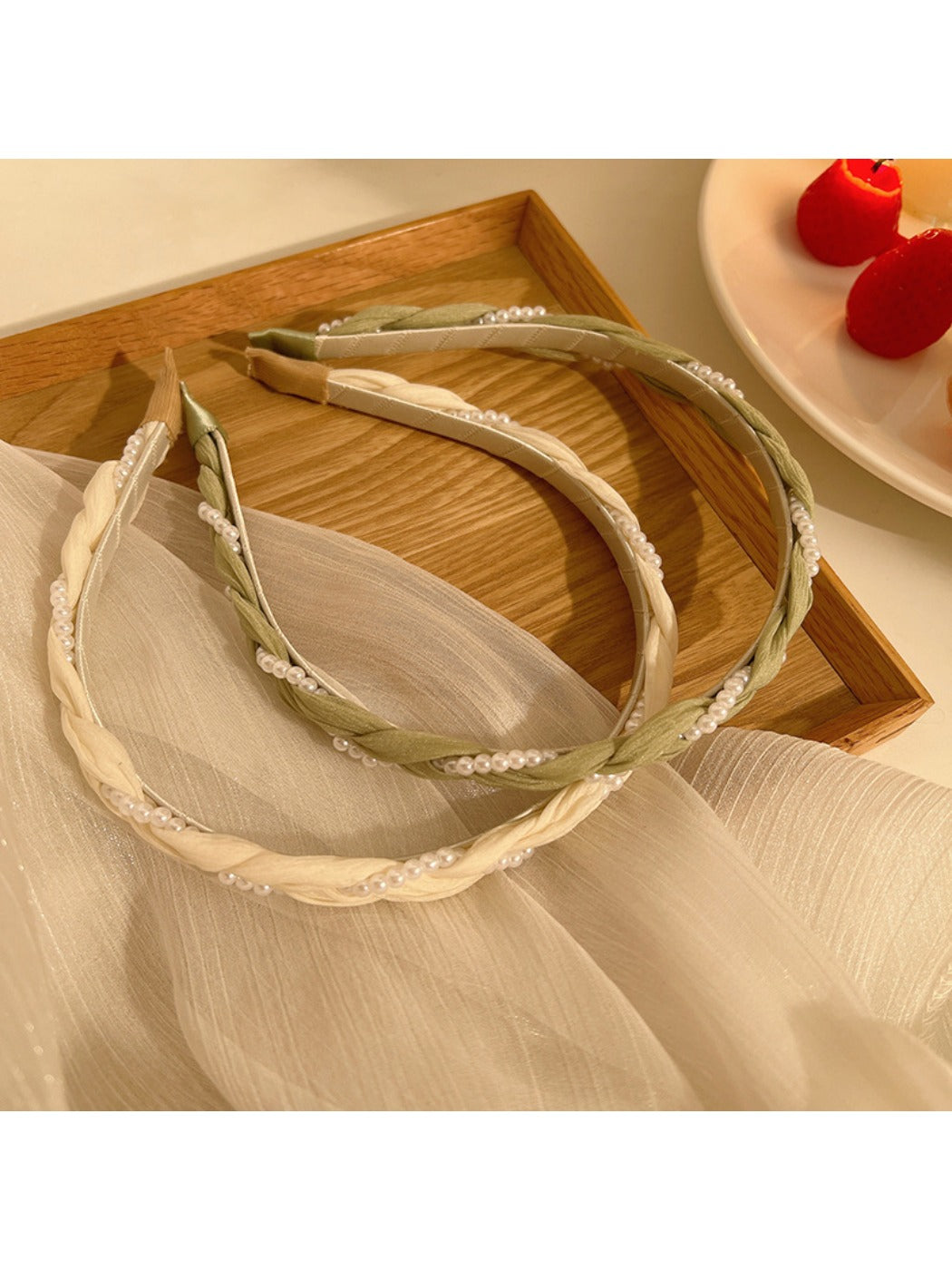 Top view of gold wire headband adorned with evenly spaced small white beads