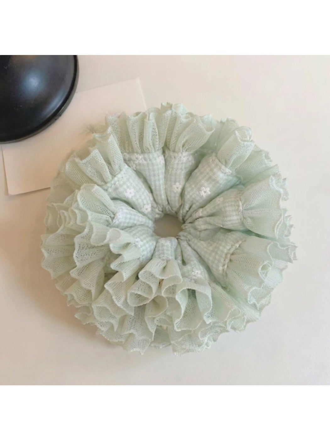 Mint green plaid tulle scrunchie with layered ruffles on a white background