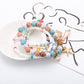 Lovra stackable bracelet worn on wrist with ocean-inspired charms and beads