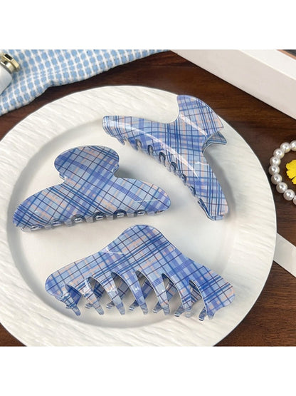 Side view of blue plaid shark hair claw clip showing curved teeth