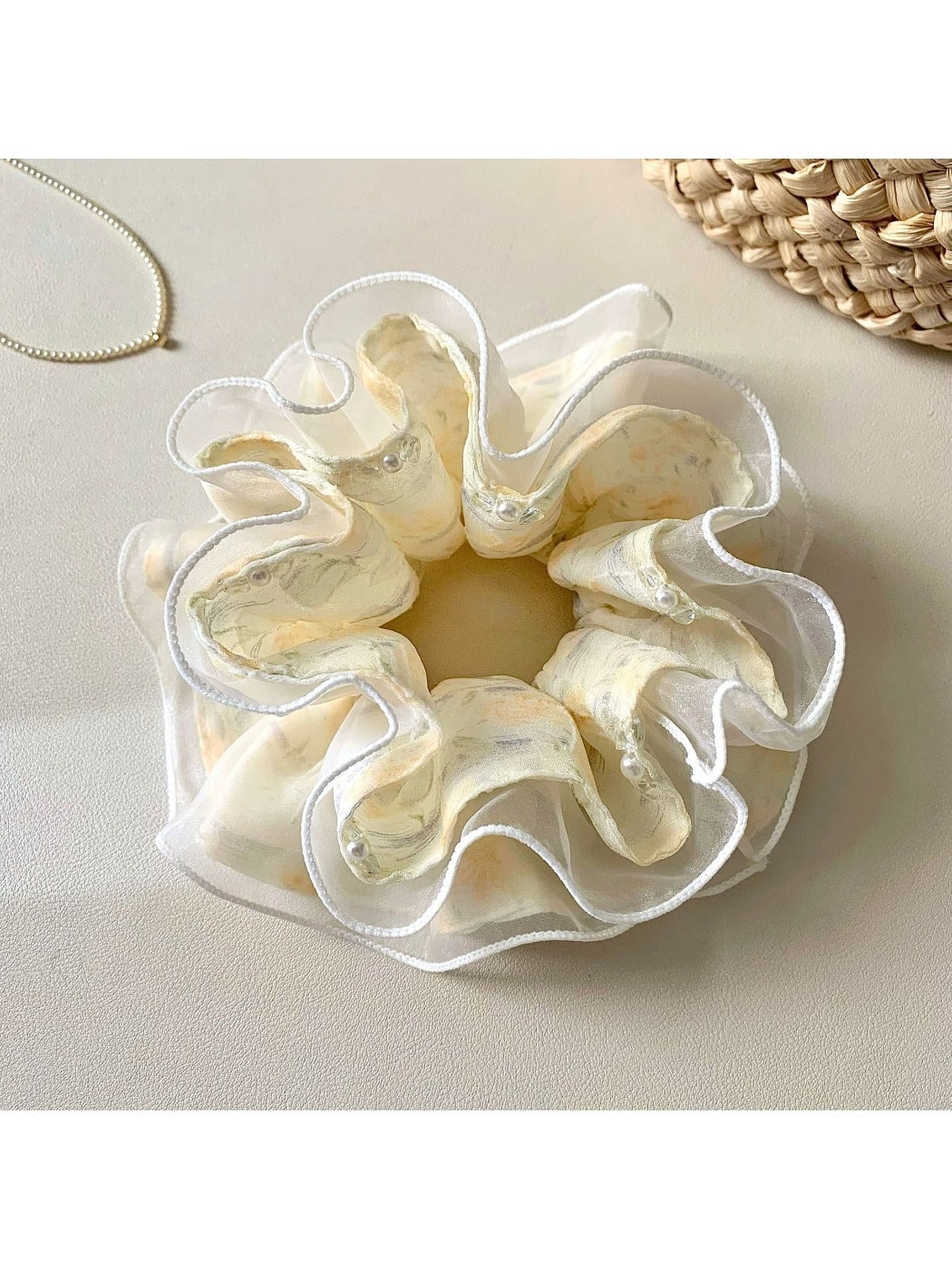 Close-up of Gifty chic printed ruffled scrunchie with floral pattern on fabric