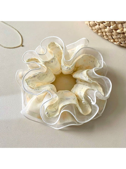 Close-up of Gifty chic printed ruffled scrunchie with floral pattern on fabric