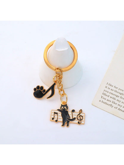 Cartoon cat piano keychain with metal keyring and detailed cat face design