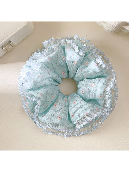 Double layer scrunchie with blue floral design displayed flat on surface