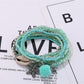 Lovra bracelet close-up showing clasp and small gold and silver beads